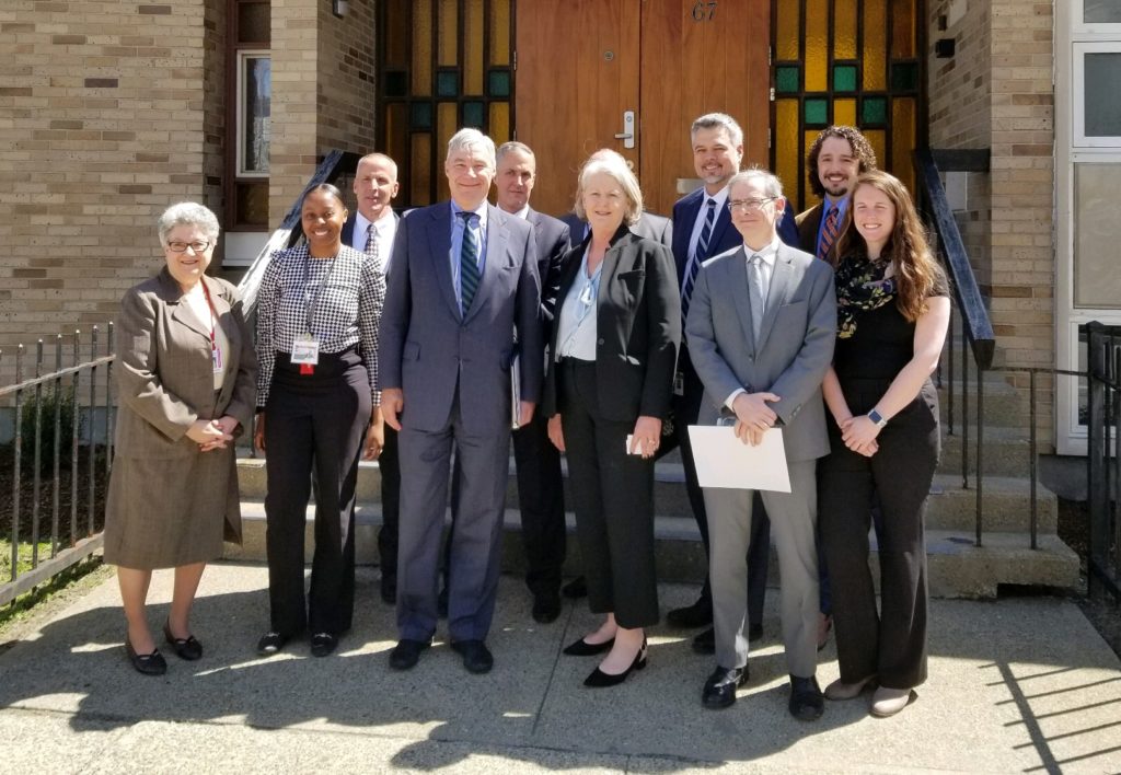 Senator Sheldon Whitehouse standing with CRJ staff outside Houston House on April 29, 2019.