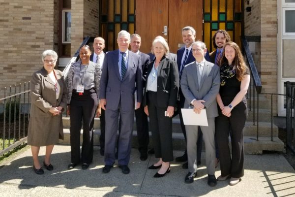 Senator Sheldon Whitehouse standing with CRJ staff outside Houston House on April 29, 2019.
