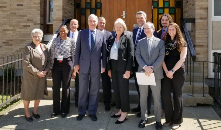 Senator Sheldon Whitehouse standing with CRJ staff outside Houston House on April 29, 2019.