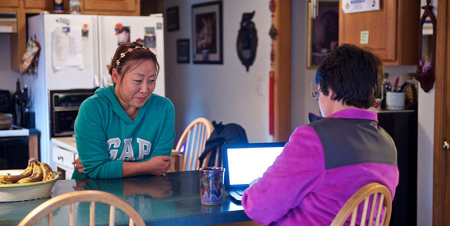 Two women sitting at a table talking