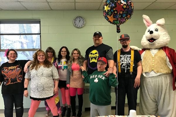 Community Strategies clients and staff at an 80s-themed party