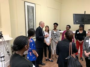 John Larivee leading a group of people through McGrath House