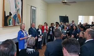 Ellen Donnarumma speaking to a packed crowd in the front room at McGrath House