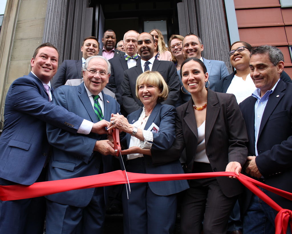 Massachusetts state legislators standing on the front steps of McGrath House