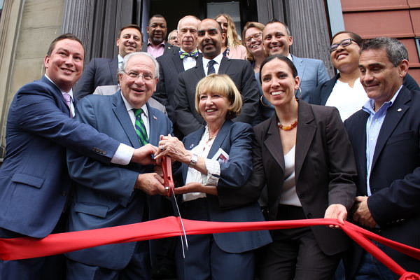 Massachusetts state legislators standing on the front steps of McGrath House