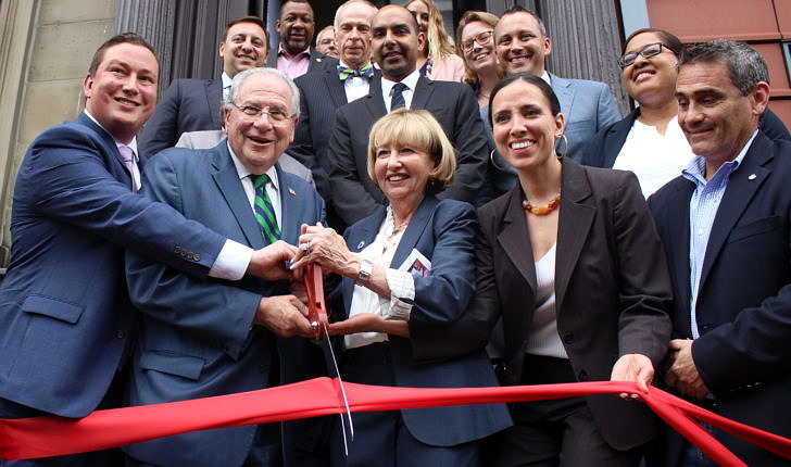 Massachusetts state legislators standing on the front steps of McGrath House