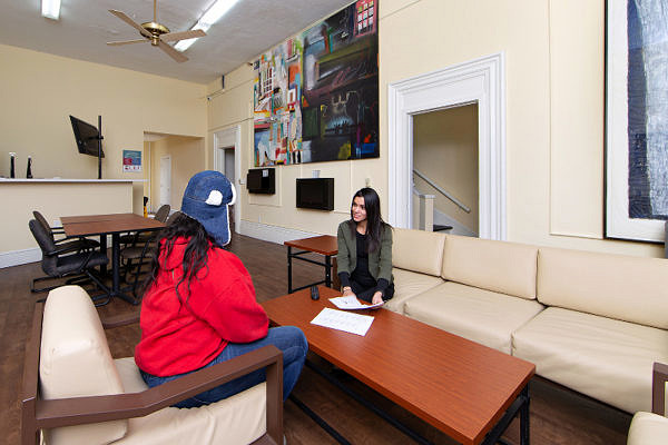 Two women sitting on opposite sides of a low table