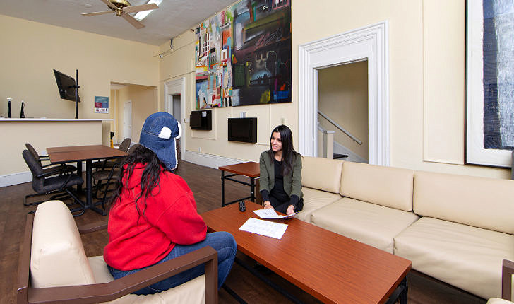 Two women sitting on opposite sides of a low table