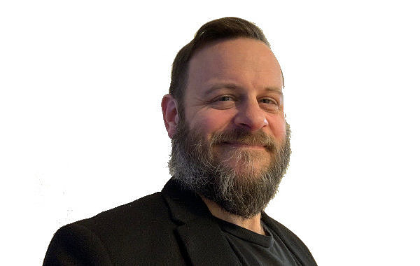 Portrait photo of Joe Jarvis looking into the camera