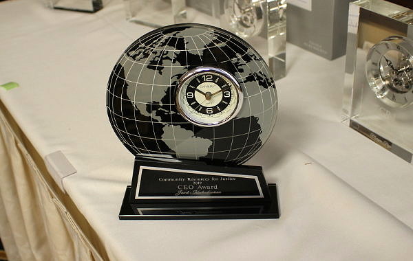 A commemorative clock sits on a white table