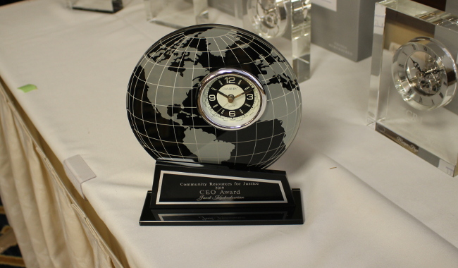 A commemorative clock sits on a white table