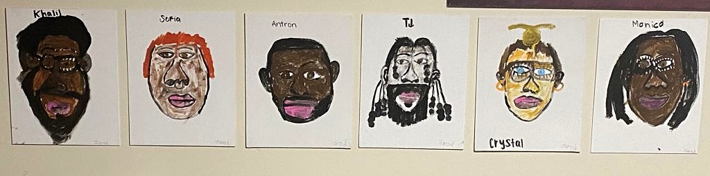 A row of six paintings of people's faces displayed on a wall