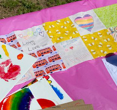 Colorful squares of cloth sewn together to make a quilt