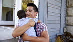 Photo of a man hugging a child